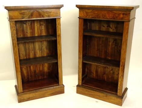 A pair of walnut open bookcases, in Victorian style, with two adjustable shelves, on a plinth base, 102cm high, 56cm wide.