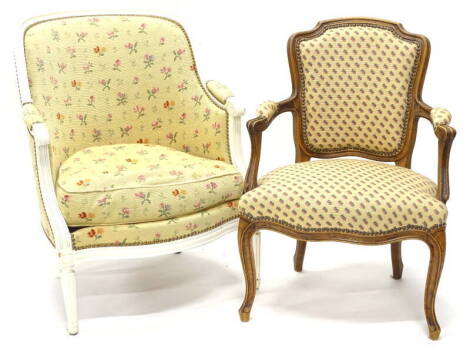 A French walnut open armchair, with a padded back, armrest and seat, upholstered in gold pattern fabric, on cabriole legs, and a French cream painted tub type chair, with gold floral fabric, on turned fluted legs.