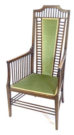 An Edwardian Arts & Crafts style armchair, with a spindle turned back, side supports and stretchers, a padded back rest seat on square tapering legs. Provenance: The Estate of Miss Rachel Monson.