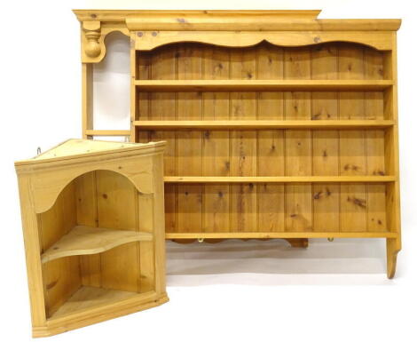 A collection of pine furniture, two plate racks each with shelves, 108cm & 104cm wide respectively, and a pine corner cabinet, 52cm wide.