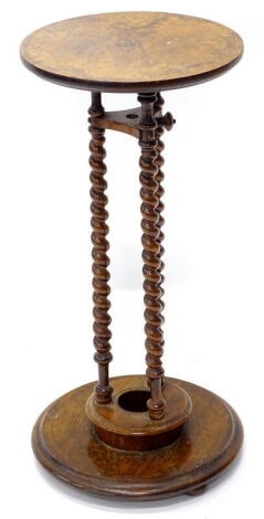 A Victorian walnut occasional table, the circular top on spirally turned supports, with platform, 61cm high the top, 58cm diameter.