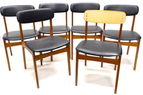 A set of six 1960s teak dining chairs, each with black PVC padded backs and seats. The upholstery in this lot does not comply with the 1988 (Fire & Fire Furnishing) Regulations, unless sold to a known exporter or upholsterer it will be cut from the frame