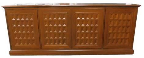 An oriental hifi cabinet, the top with three hinged sections, above four lattice panelled doors, on a plinth, 230cm wide.