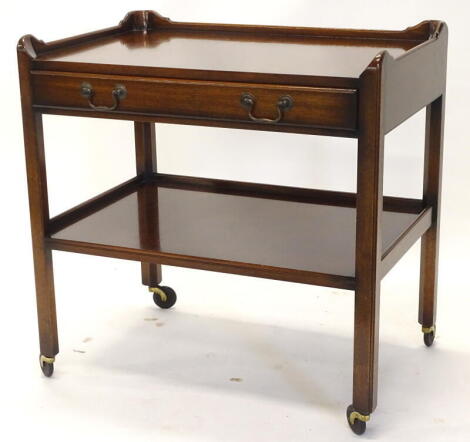 A walnut galleried trolley, with a frieze drawer above an under tier on castors, 76cm wide.