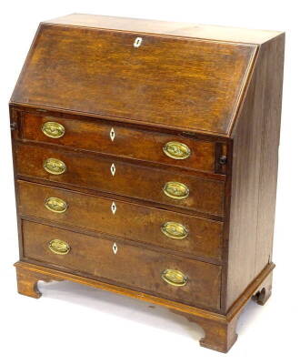 A George III oak and mahogany cross banded bureau, the fall enclosing a fitted interior above four graduated drawers, each with oval brass drop handles, on bracket feet, 89cm wide. Provenance: The Estate of Miss Rachel Monson.