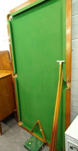 A quarter size mahogany snooker table, with cues and balls.