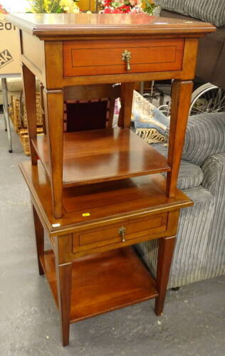 A pair of yew veneered two tier bedside tables, each with a drawer.