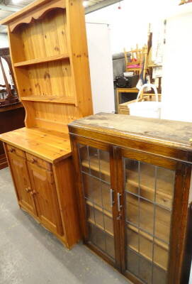 A pine dresser, and an oak bookcase with two leaded glass doors.