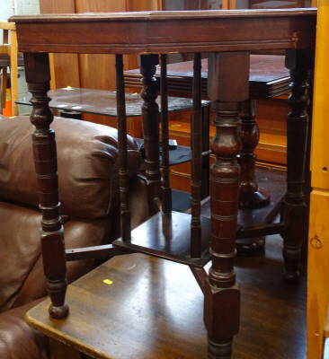 An Edwardian mahogany two tier occasional table on turned legs.