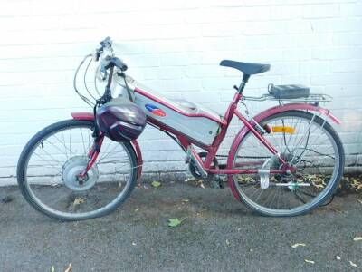 A Powabyke electric bicyle, red and silver metal chassis, with power pack and helmet.