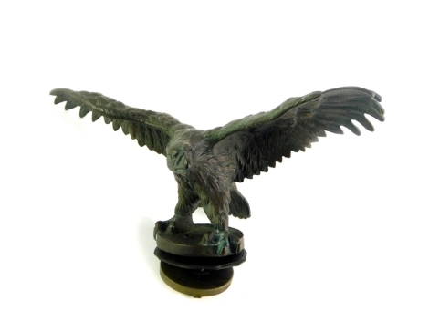 A vintage early 20thC bronze eagle car mascot, model perched with it's wings extended, 7.5cm high, 26cm wide.