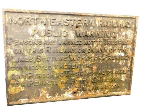 A North Eastern Railway black cast iron rectangular sign, 'North Eastern Railway Public Warning, Persons Are Warned Not To Trespass On This Railway, Or On Any Of The Lines, Stations, Works, Or Premises Connected Therewith. Any Persons So Trespassing Is L