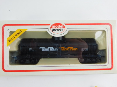 A Bachmann OO gauge locomotive chassis, 4-6-0, model power old time wooden passenger car, Denver and Rio Grande with a Western tank car, Hudson's Bay Oil and Gas, chemical tank wagon, Michigan Alkaline Company and another tank train, all boxed. (5) - 5