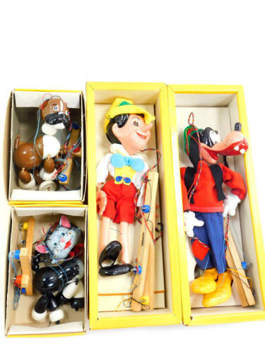 Four Pelham puppets, boxed, comprising Pinocchio, Goofy, Cat and Bengo.