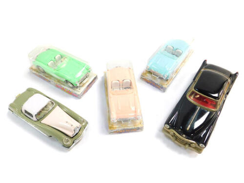 Three Golden classic friction powered classic cars, boxed, together with a tin plate friction driven Chinese Cadillac. (5)