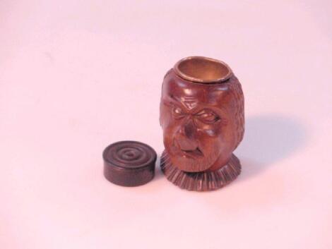 A carved treen head, with brass inkwell receiver and a turned ebony circular pill box