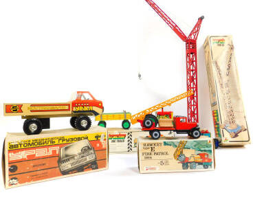 Three Kovap tin plate toys, boxed, comprising a Hawkeye type E 1924, a tractor and trailer and a crane, together with a Russian sports car. (4)