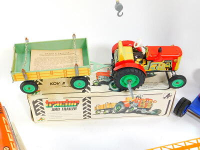 Three Kovap tin plate toys, boxed, comprising a Hawkeye type E 1924, a tractor and trailer and a crane, together with a Russian sports car. (4) - 4