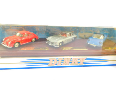 A Dinky die cast classics sports cars series one three car set, comprising a Porsche 356A coupe 1958, Mercedes Benz 300SL gull wing 1935, and a Ferrari D2046GTS93, on a wooden stand, DY-902, together with a Dinky 1967 Jaguar E-Type Mark 1 ½, DY-1B, both b - 3