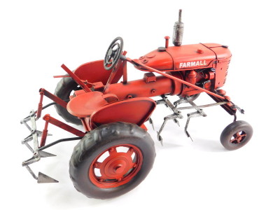 A tin plate red Farmall tractor, 34cm wide. - 2