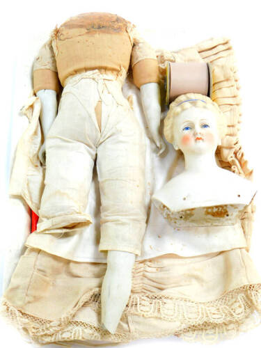 A late 19th/early 20thC bisque headed doll, number 24, modelled with closed mouth, blue glass eyes and hair, with a blue hair band, straw filled fabric body, with bisque legs and arms, approx 61cm high. (AF)