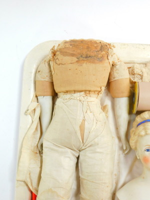 A late 19th/early 20thC bisque headed doll, number 24, modelled with closed mouth, blue glass eyes and hair, with a blue hair band, straw filled fabric body, with bisque legs and arms, approx 61cm high. (AF) - 2