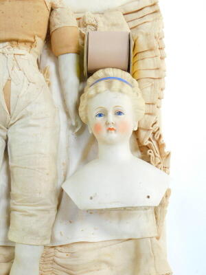 A late 19th/early 20thC bisque headed doll, number 24, modelled with closed mouth, blue glass eyes and hair, with a blue hair band, straw filled fabric body, with bisque legs and arms, approx 61cm high. (AF) - 3