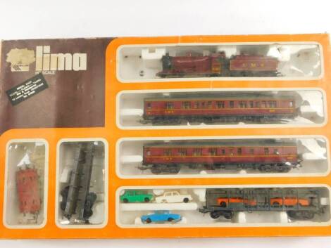 A Lima HO scale model train set, containing an LMS engine, 060, 4683, LMS red livery, together with two coaches and assorted wagons, boxed.