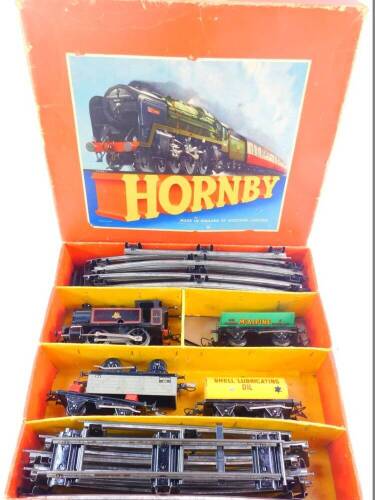 A Hornby O guage train set, with a British Rail tank locomotive, black livery, 3/82011, four wagons and rails, boxed.
