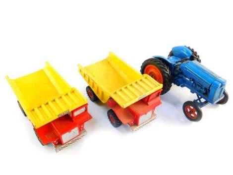 A Chad Valley die cast model of a Fordson Major Tractor, together with two Dinky Toys Aveling Barford SN 35 dump trucks. (3)