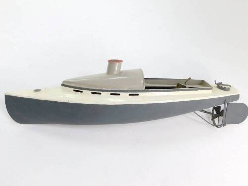 An early 20thC steam driven metal framed model motor cruiser, painted in grey and white, 50cm wide.