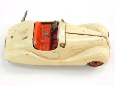 A Schuco Examico 4001 tin plate clockwork motor car, cream with red interior, with key and box. - 2