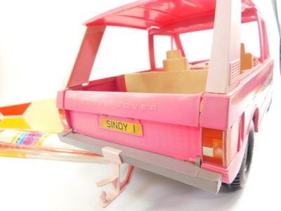 A Sindy Range Rover, registration Sindy !, two tone pink, 61cm wide, together with a Sindy surf board, 47cm wide. (2) - 4