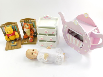 A Horsman doll, c1982, No.4641., a pink and white polka dot wooden teapot form doll's house, 42cm wide., a child miniature chest of one long over four short drawers and a pair of Winnie and Tigger bookends. (1 tray)