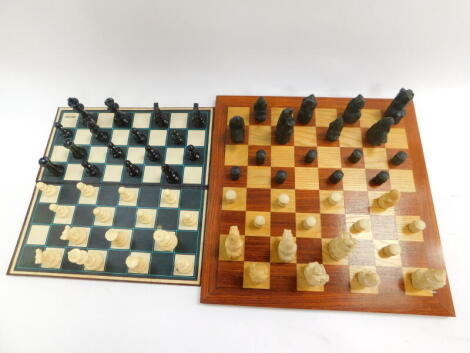 A replica resin Lewis chess set, with a wooden chess board, 47cm diameter, together with a plastic Staunton type chess set with a Spears folding chess board.