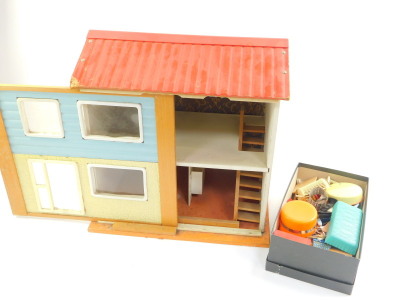 A mid 20thC wooden and plastic doll's house, with two floors, furniture and accessories. - 3