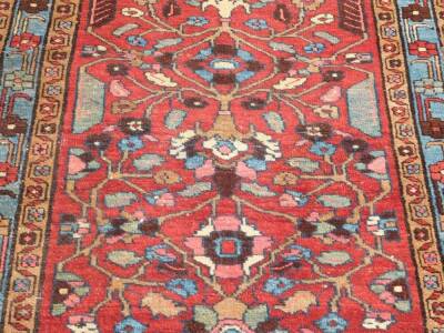 A Hammadan carpet runner, with stylised floral central field on red ground, enclosed by triple borders, with a turquoise central band, 320cm x 92cm. - 3