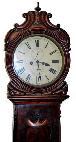 William Dobbie, Falkirk. A 19thC Scottish mahogany drumhead longcase clock, with a carved scroll case raised above a widening trunk with arched door, on a panel base terminating in compressed bun feet, the 34cm diameter Roman numeric dial with subsidiary