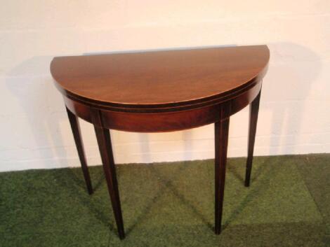 A Sheraton mahogany demi-lune card table