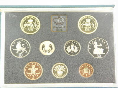 The United Kingdom Uncirculated Coin Collections, 1983-1985, 1987-1994., Commonwealth Games Commemorative £2 coin 1986., 1989 Royal Mint cased uncirculated coin collection., Millennium silver £5 coin, case., and a Queen Silver Jubilee 1977 philatelic stam - 2