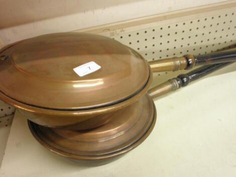 Two Victorian copper warming pans with turned wood handles<br