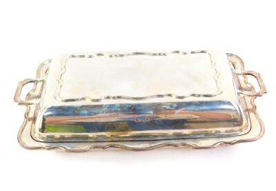 A George V silver entree dish and cover, of serpentine form, Sheffield 1931, 46.70oz.