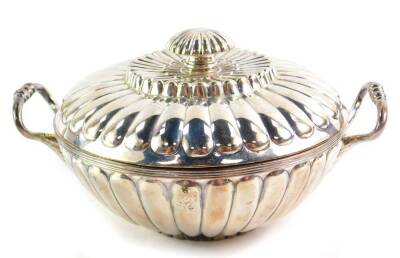 A George III silver twin handled porringer and cover, of fluted form, maker's initials T H, London 1804, 11.70oz.