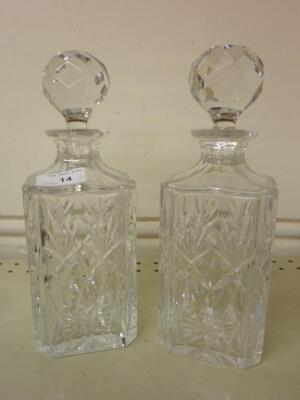 A pair of cut glass square section decanters and stoppers <br