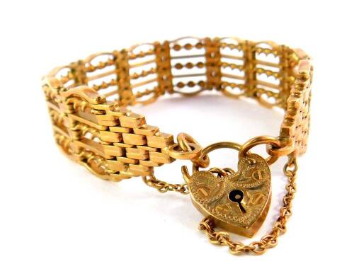 A 9ct gold six bar gate bracelet, on a heart shaped padlock clasp, with safety chain as fitted, 38.6g.