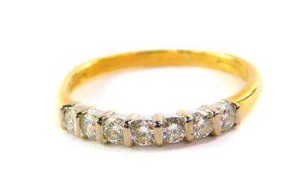 An 18ct gold and diamond half hoop eternity ring, set with seven brilliant cut diamonds, approx 0.3cts, size P, 2.5g.