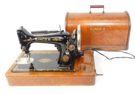 A Singer oak cased electric sewing machine.