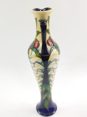 A Moorcroft pottery jug, decorated in the Wisteria pattern by Phillip Gibson, limited edition 54/150, 2005, of elongated balaster form, painted and impressed marks, 32cm high. - 2