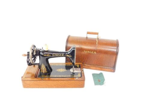 An oak cased Singer sewing machine.