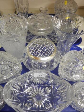 A large quantity of cut and moulded glass vases